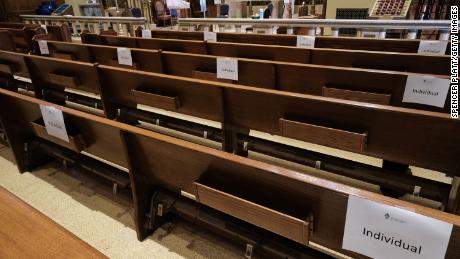 Church pews are marked with signs to allow congregants to practice social distancing. 